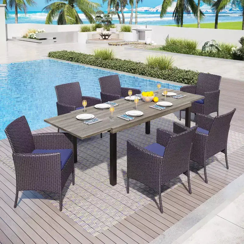 Captiva Designs 7-teiliges erweiterbares Outdoor-Garten-Essset mit Stahlesszimmertisch und Rattanstühlen mit Armlehnen in Halbmondform