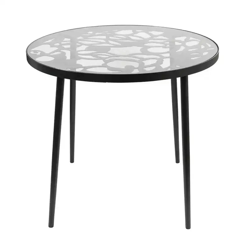 LeisureMod Devon 5-Piece Outdoor Dining Set - Round Glass Table with 4 Black Flower Design Stackable Chairs