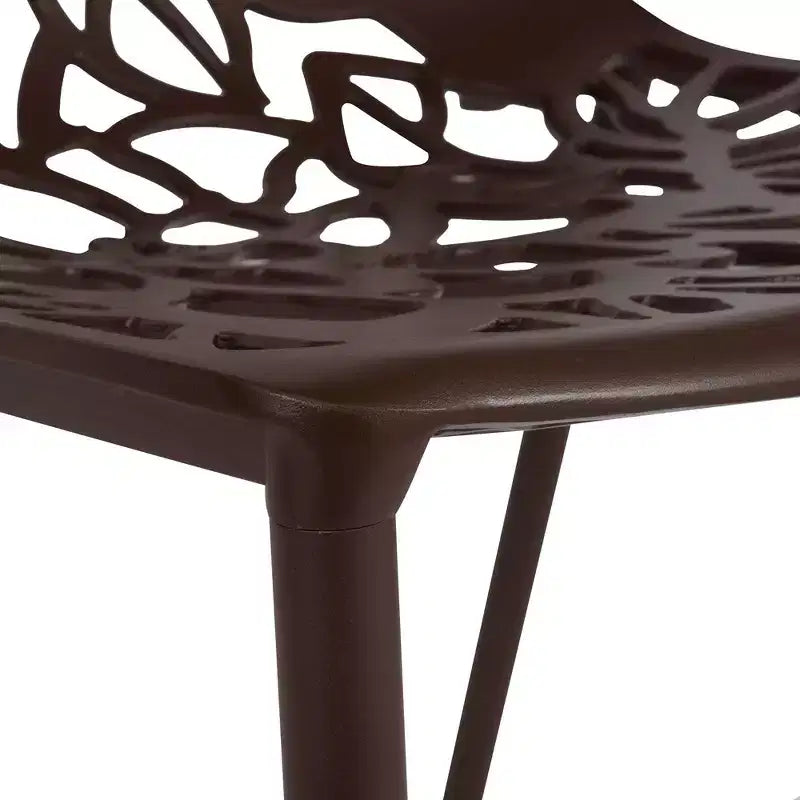 LeisureMod Devon 5-Piece Outdoor Dining Set - Round Glass Table with 4 Black Flower Design Stackable Chairs