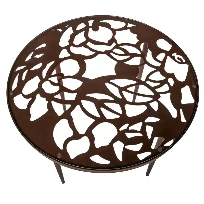LeisureMod Devon 5-Piece Outdoor Dining Set - Round Glass Table with 4 Black Flower Design Stackable Chairs